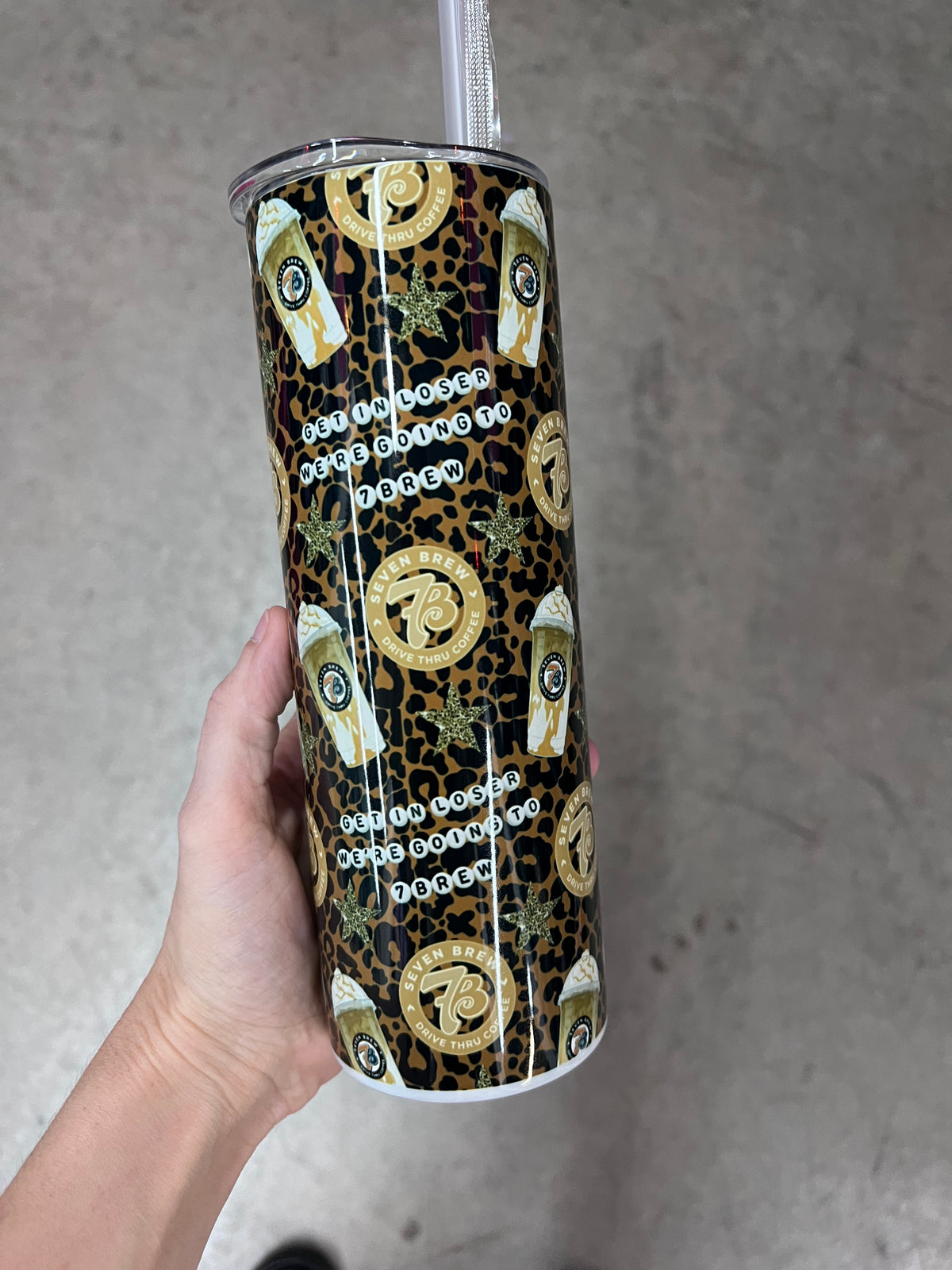 Close-up of the Get in loser we are going to 7 Brew text on a custom leopard print insulated tumbler