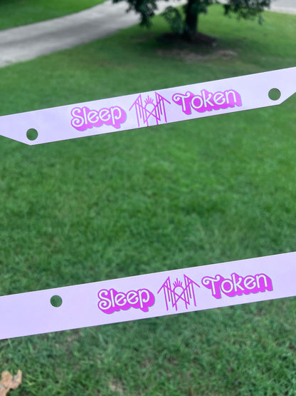 KimTheGrimm Sleep Token Barbie pink sublimated license plate frame held outside in grass background.⁠