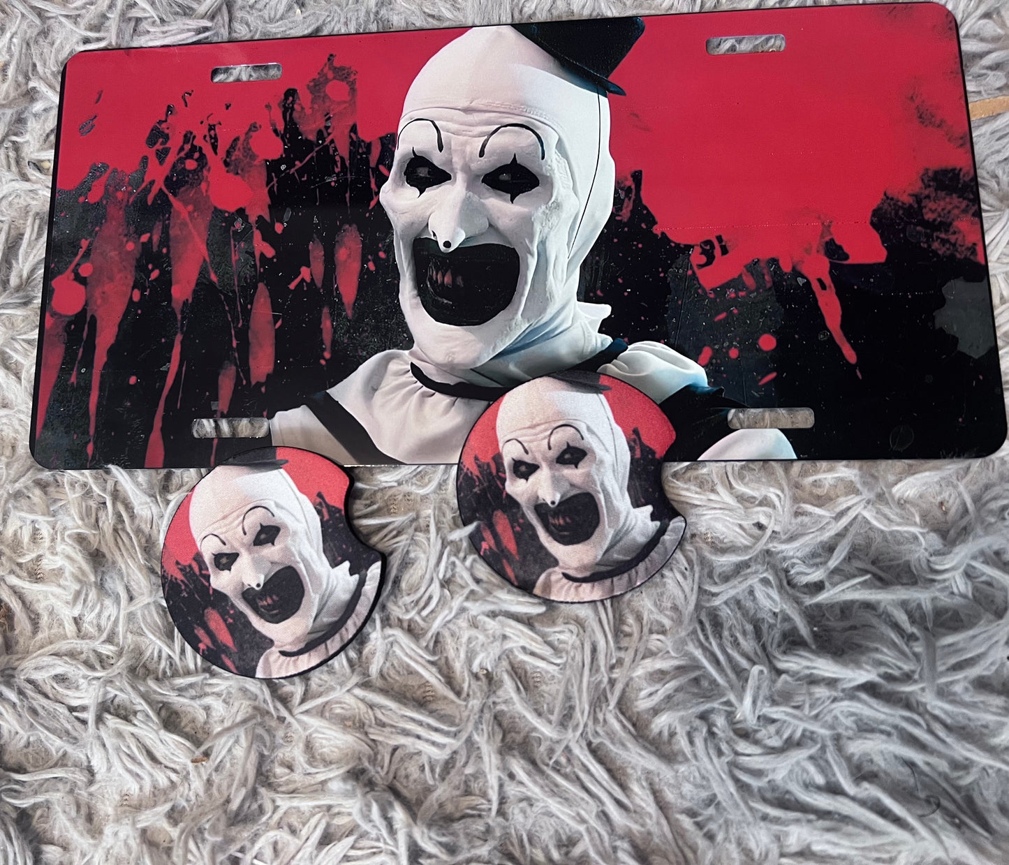 Art The Clown Horror Car Accessory Set | Terrifier Inspired Car Coasters & Vanity Plate | Spooky Horror Fan Car Decor featuring the design artwork