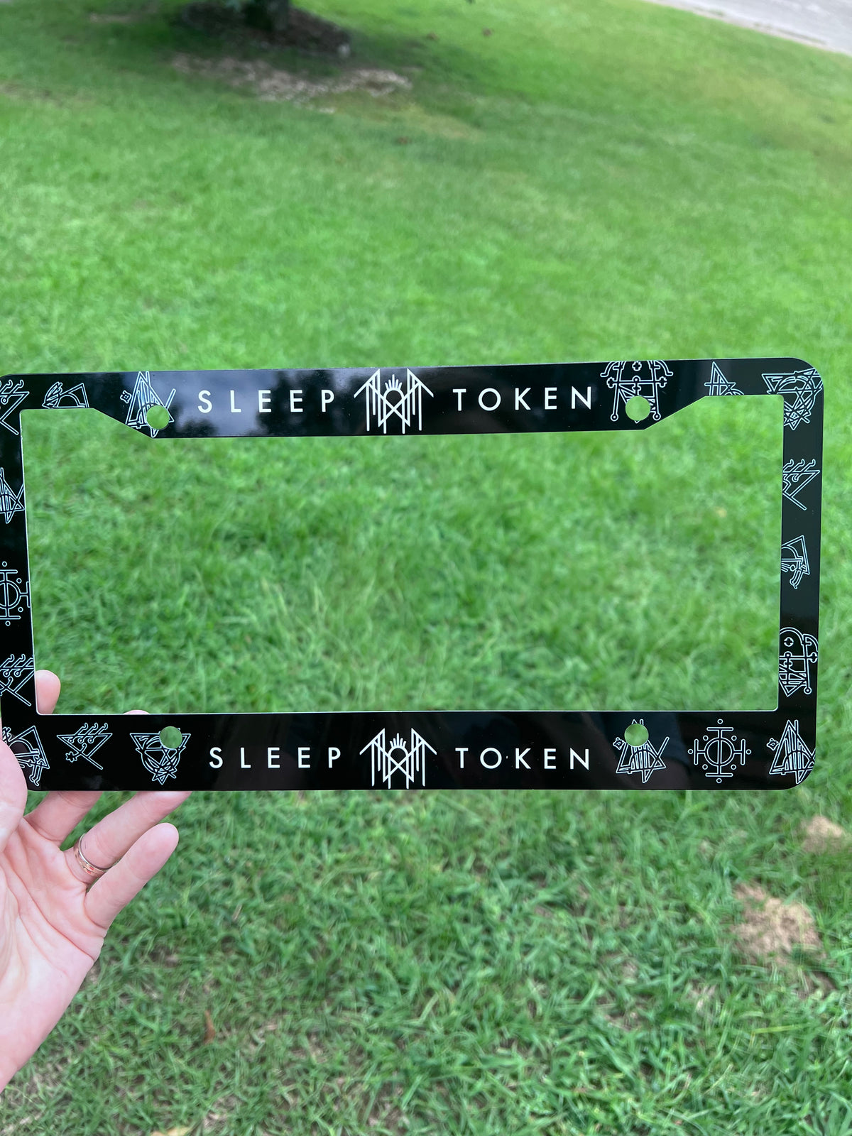 Straight-on product view of the custom Sleep Token worship runes car license plate holder⁠