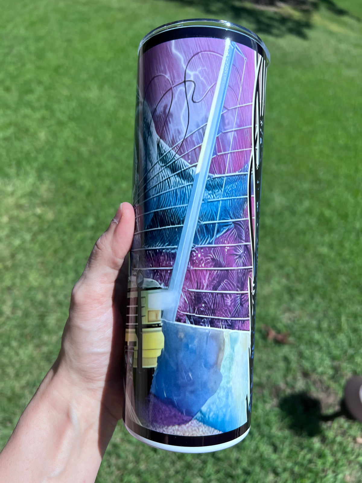 Retro 90s Jurassic Park 20oz skinny tumbler featuring a neon-purple sci-fi wrap with a T-Rex head and tour SUV.⁠