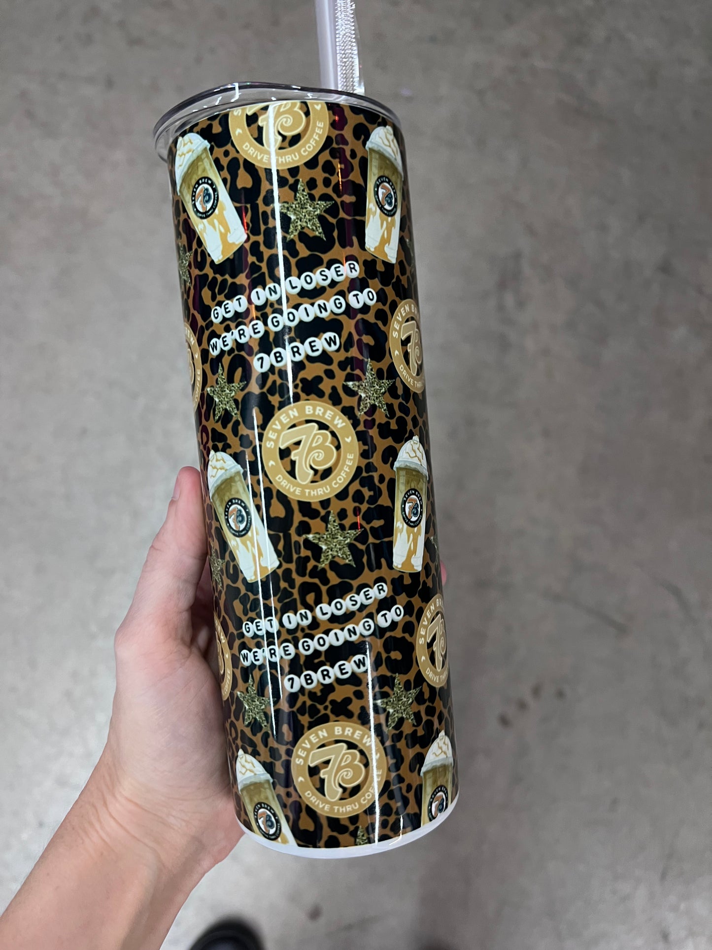 Detailed view of the 7 Brew round logo and iced coffee cup graphics on a custom tumbler