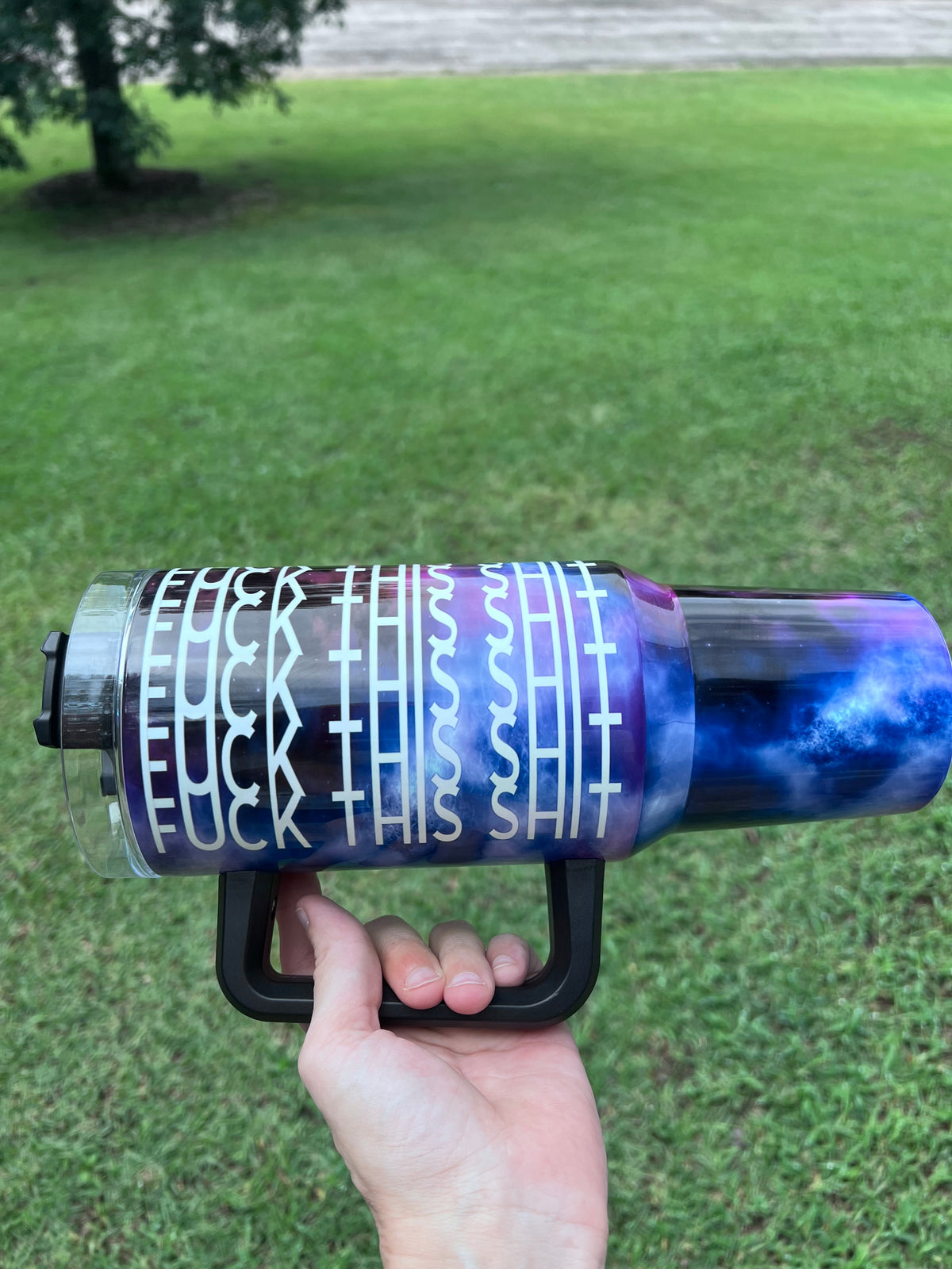 Deep purple and blue galaxy 40oz insulated tumbler with white geometric tribal print and ergonomic handle.⁠