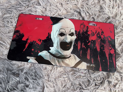 Art The Clown Horror Car Accessory Set | Terrifier Inspired Car Coasters & Vanity Plate | Spooky Horror Fan Car Decor featuring the design artwork