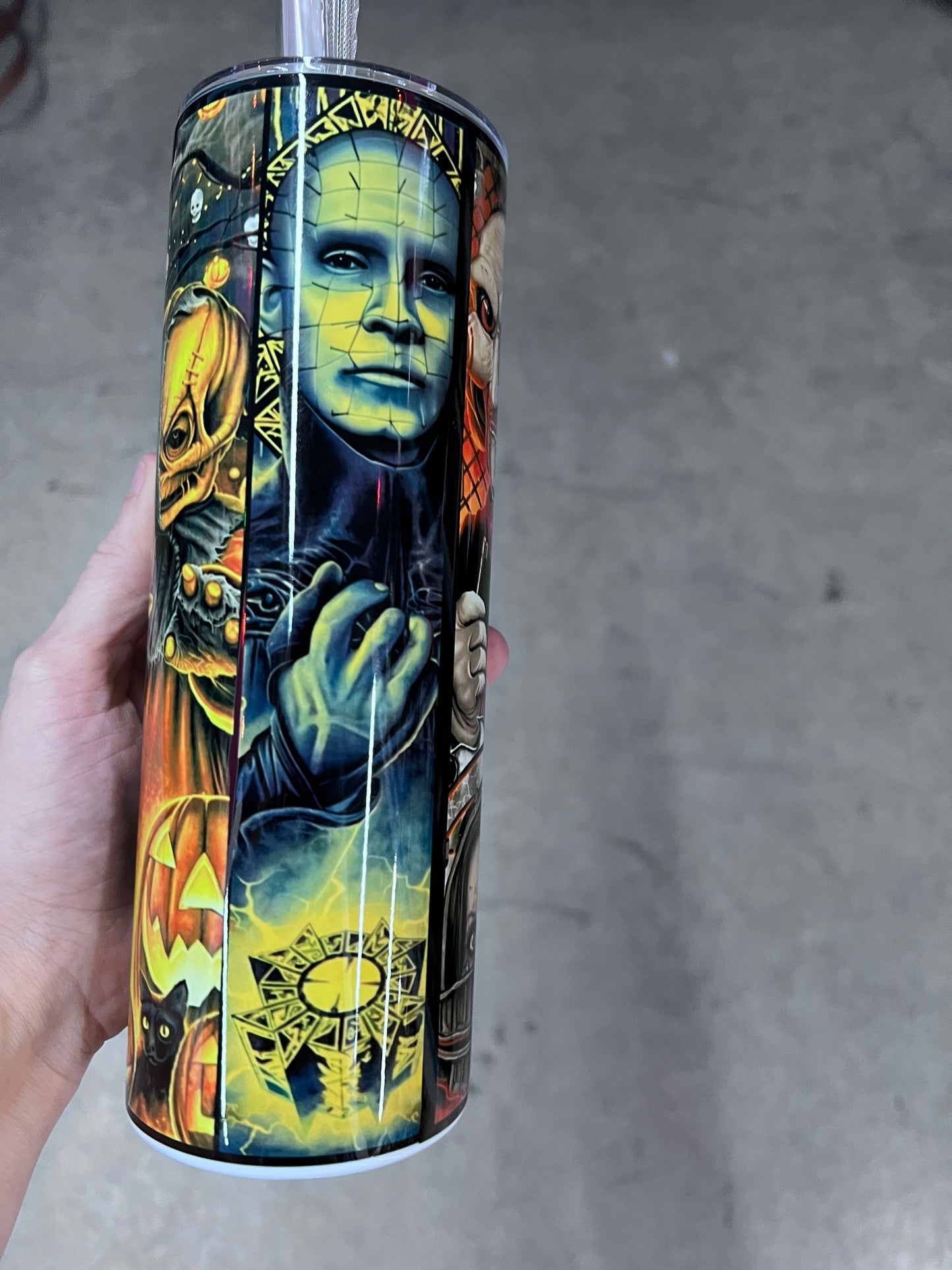 Horror movie character collage tumbler featuring Frankenstein, Jigsaw, Ghostface, Chucky, and other classic horror characters
