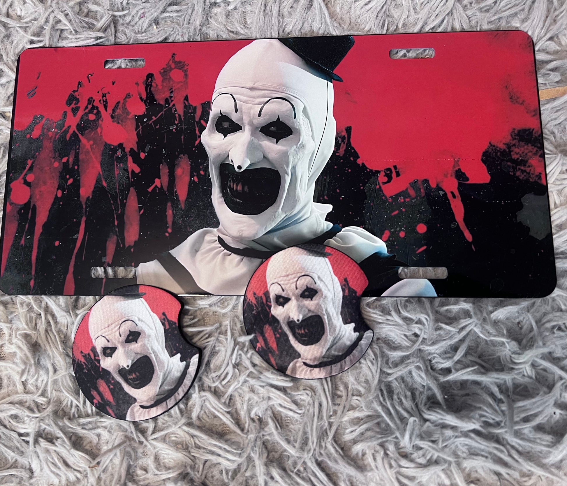 Art The Clown Horror Car Accessory Set | Terrifier Inspired Car Coasters & Vanity Plate | Spooky Horror Fan Car Decor featuring the design artwork