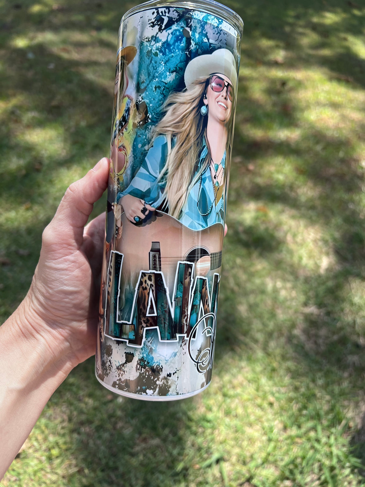 Lainey Wilson country music 20oz stainless steel tumbler cup with cowboy hat and acoustic guitar.