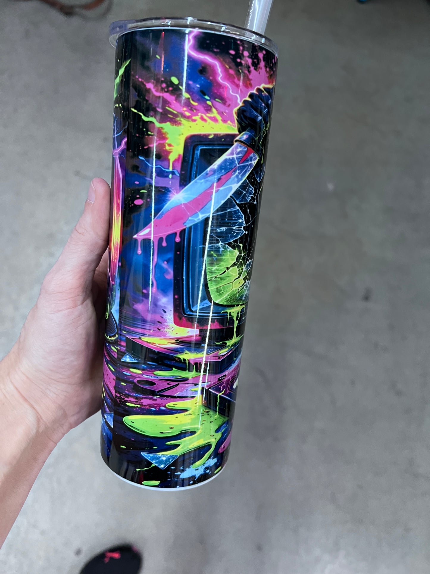 Close-up of Ghostface reaching hand graphic with neon green and pink slime drips⁠