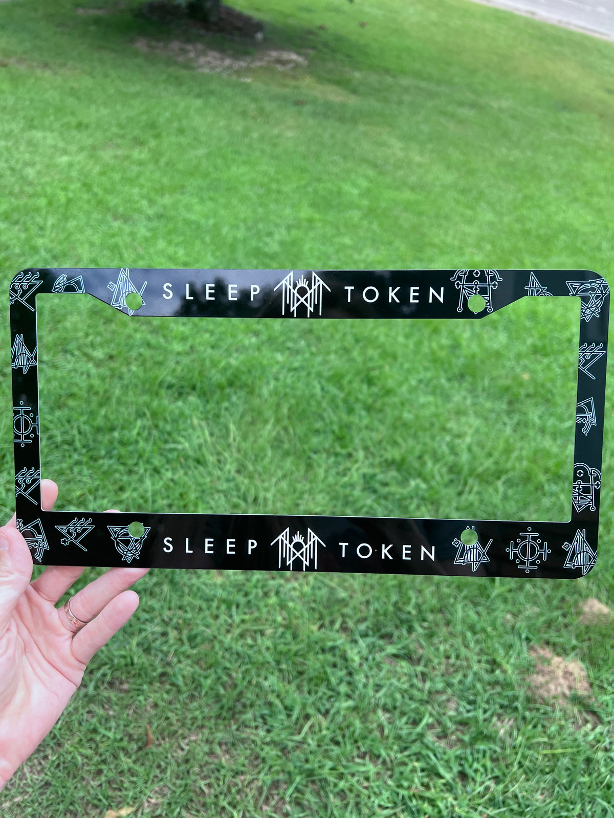 Sleep Token license plate frame featuring white band lettering and rune symbols against a black background⁠