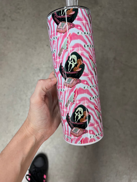 A hand holding a custom pink and white wavy patterned tumbler featuring the text "FINAL GIRL ENERGY" above a Ghostface mask holding a pink rotary phone