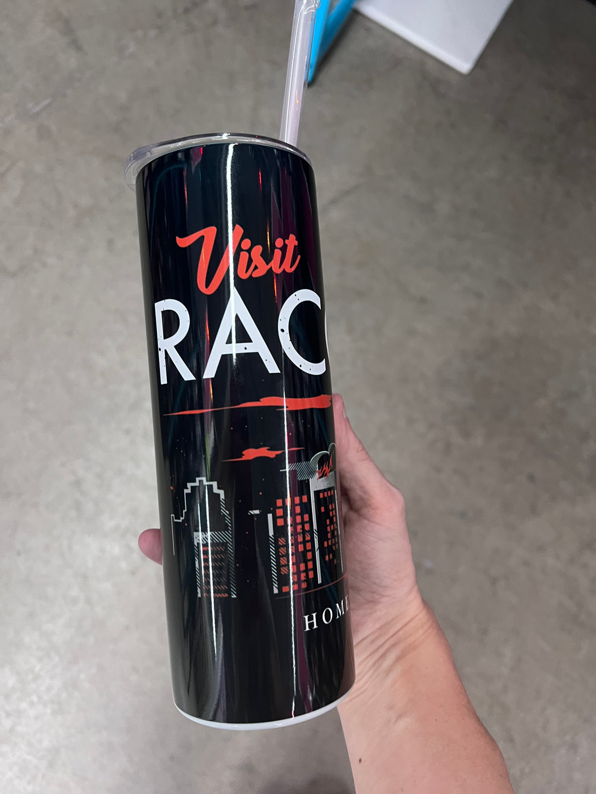 A hand holding a custom black tumbler featuring a red and white umbrella logo above a smoky grey and red city skyline.  
 For the Text Fo