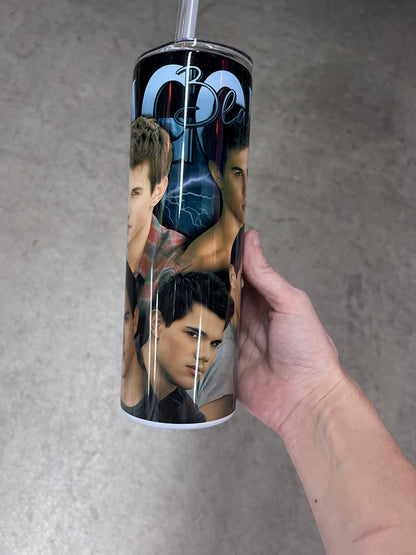 A hand holding a custom Twilight tumbler featuring a multi-image collage of Jacob Black set against a dark background with blue lightning strikes.