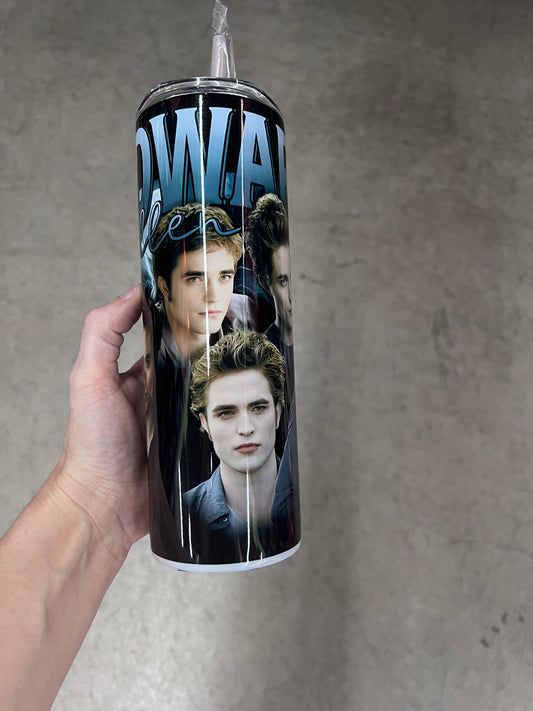 A hand holding a custom Twilight tumbler featuring the name "EDWARD" in bold blue text with "Cullen" in a cursive script, layered over an image of Edward Cullen in a black v-neck shirt.